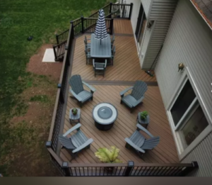 an extended deck on back of home with furniture