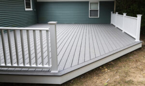 a gray-toned deck with railing and balusters on back of home